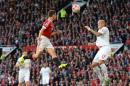 Manchester United's Spanish midfielder Ander Herrera (L) goes up for a header as Liverpool's defender Martin Skrtel tries to defend during the English Premier League football match at Old Trafford in Manchester, England, on September 12, 2015