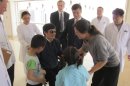 In this photo released by the US Embassy Beijing Press Office, blind lawyer Chen Guangcheng, in wheel chair, meets his wife Yuan Weijing, right, daughter Chen Kesi, in blue shirt at second right, and son Chen Kerui, left, at a hospital in Beijing, Wednesday, May 2, 2012. U.S. ambassador to China, Gary Locke stands at Chen's right, and man at back in dark suit is language attache James Brown. (AP Photo/U.S. Embassy Beijing Press Office, HO)