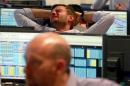 A trader from BGC, a global brokerage company in London's Canary Wharf financial centre reacts during trading