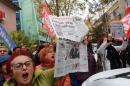 Demonstrators hold copies of Turkish newspaper Cumhuriyet outside the newspaper's office in Ankara during a protest against the detention of journalists