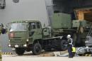 A vehicle carrying a PAC-3 missile interceptor arrives at a port on Ishigaki Island, Okinawa prefecture, southwestern Japan Saturday, Feb. 6, 2016. North Korea has moved up the window of its planned long-range rocket launch to Feb. 7-14, South Korea's Defense Ministry said Saturday. The launch, which the North says is an effort to send a satellite into orbit, would be in defiance of repeated warnings by outside governments who suspect it is a banned test of ballistic missile technology. (Koji Harada/Kyodo News via AP) JAPAN OUT, MANDATORY CREDIT