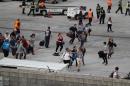 People seek cover on the tarmac of Fort Lauderdale-Hollywood International airport after a shooting took place near the baggage claim on January 6, 2017