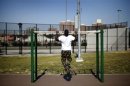 A man works out in an outdoor "Adult Playground" exercise area at Macombs Dam Park in the Bronx section of New York City