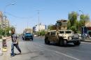 An Iraqi army armoured vehicle patrols a street in Baghdad's commercial district of Karrada on August 11, 2014