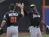 Miami Marlins shortstop Adeiny Hechavarria, right, celebrates the Marlins 8-4 victory over the New York Mets with Miami Marlins second baseman Derek Dietrich (51) at the conclusion of their baseball game in New York, Sunday, June 9, 2013. (AP Photo/Kathy Willens)