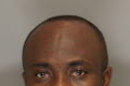 This undated booking photo provided by the Cobb County Sheriff in Marietta, Ga., shows Ernest Addo, 48, who was arrested on Aug. 24, 2012 for identity theft and practicing medicine without a license. When Addo's friend went to Africa for a year, he assumed his buddy's identity, all the way down to the man's medical license. Authorities said Addo saw up to 500 patients at five senior homes in Columbia, S.C., before he was discovered. (AP Photo/Cobb County Sheriff)