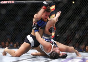 Miesha Tate, left, holds down Jessica Eye during their bantamweight fight Saturday. (AP)