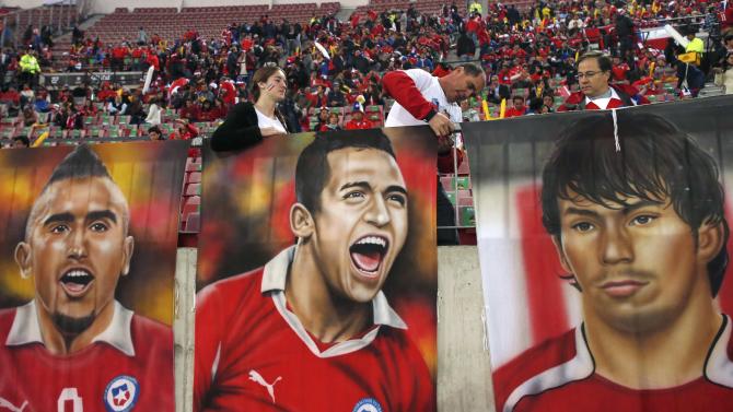 Chile fans hang posters of their players before the opening soccer match against Ecuador in the Copa America Chile 2015 at National Stadium in Santiago