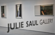 Photography of Arne Svenson hangs inside the Julie Saul Gallery on Thursday, May 16, 2013 in New York. Residents of a New York luxury apartment building are upset over the exhibition by Svenson who secretly made their pictures from his window across the street. (AP Photo/Bebeto Matthews)