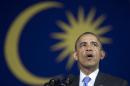 With a Malaysian flag behind him, President Barack Obama speaks during a town hall meeting at Malaya University in Kuala Lumpur, Malaysia, Sunday, April 27, 2014. (AP Photo/Carolyn Kaster)