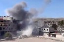 In this image taken from video obtained from the Shaam News Network, which has been authenticated based on its contents and other AP reporting, smoke rises from buildings due to heavy shelling in Maadamiyeh south of Damascus, Syria, on Thursday, March 14, 2013. (AP Photo/Shaam News Network via AP video)