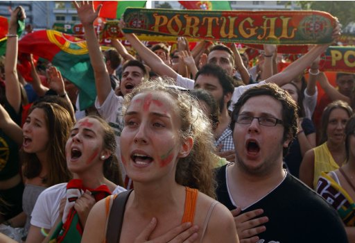 Portuguese soccer fans sing the national anthem before the semi final Euro 2012 soccer match between the Portugal and Spain at a public screening in Lisbon