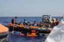 Surviving migrants are brought aboard Irish and Italian Navy life-boats in the area where their wooden boat capsized and sank off the coast of Libya