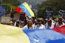 Opposition supporters shout during a rally to commemorate International Women's Day and in support of jailed opposition leaders, Leopoldo Lopez and Antonio Ledezma, in Caracas