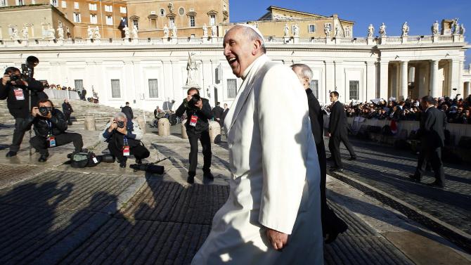 Pope Francis, who&#39;s 78th birthday is today, smiles as he arrives to lead his general audience at the Vatican