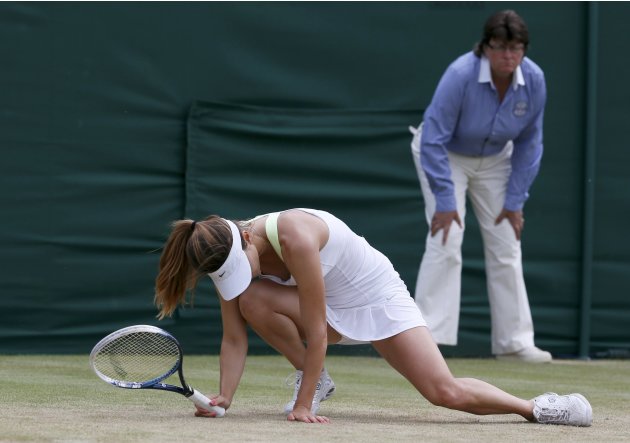 Tsvetana Pironkova of Bulgaria slips during her women's singles tennis match against Agnieszka Radwanska of Poland at the Wimbledon Tennis Championships, in London
