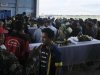 Freeport workers gather around the coffins of their colleagues who died from a tunnel collapse, in Timika of the Papua province
