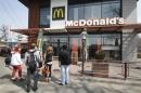 People gather outside a McDonald's restaurant, which was earlier closed for clients, in the Crimean city of Simferopol