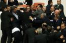 Lawmakers from the main opposition Republican People's Party and ruling AK Party scuffle during a debate on a legislation to boost police powers, at the Turkish Parliament in Ankara, late February 19, 2015