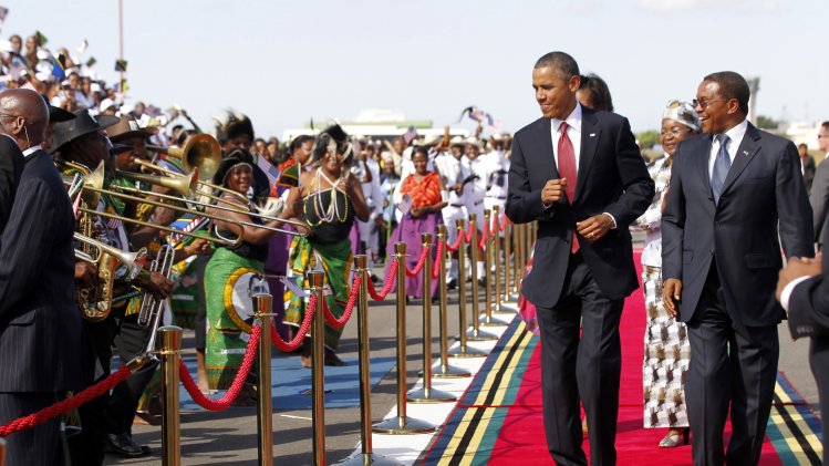 U.S. President Barack Obama dances as a Tanzanian band plays during an official arrival ceremony in Dar es Salaam