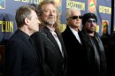 FILE - This Oct. 9, 2012 file photo shows musicians, from left, John Paul Jones, Robert Plant, Jimmy Page and Jason Bonham at the"'Led Zeppelin: Celebration Day" premiere in New York. CBS' "60 Minutes" webcast reported Monday, May 6, 2013, that former President Clinton was enlisted to ask the British rock band to get back together last year for the Superstorm Sandy benefit concert in New York. He asked, they said no. David Saltzman of the Robin Hood Foundation says he and film executive Harvey Weinstein flew to Washington to ask Clinton to make the plea. Led Zeppelin's surviving members Robert Plant, John Paul Jones and Jimmy Page were in Washington just before the Sandy concert for the Kennedy Center Honors. Led Zeppelin last played publicly at a one-night reunion in London in 2007. (Photo by Dario Cantatore/Invision/AP, file)