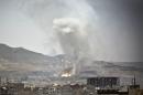 Smoke rises after a Saudi-led airstrike hit a site where many believe the largest weapons cache in Yemen's capital, Sanaa, on Tuesday, April 21, 2015. The Saudi-led coalition pounded Shiite rebels in Yemen on Tuesday, killing at least 19 in a city in the country's west, officials said. (AP Photo/Hani Mohammed)
