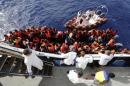Handout photo shows migrants climbing aboard the NGO Migrant Offshore Aid Station ship Phoenix as a group of 104 sub-Saharan Africans on board a rubber dinghy is rescued some 25 miles off the Libyan coast