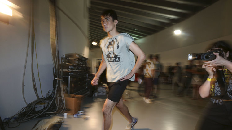 A model runs during rehearsals of the Vivienne Westwood men's Spring-Summer 2014 fashion show, part of the Milan Fashion Week, unveiled in Milan, Italy, Sunday, June 23, 2013. The shirt portrays US Army soldier Bradley Manning, who was arrested in 2010 on suspicion of having made public classified material through the website WikiLeaks. (AP Photo/Luca Bruno)