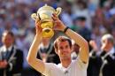 Britain's Andy Murray raises the winner's trophy on July 7, 2013, at the All England Club in Wimbledon, southwest London