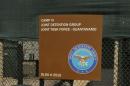 In this Feb. 2, 2016 photo, a sign for Camp 6 is posted outside the U.S. detention center at Guantanamo Bay, Cuba. President Barack Obama has refused to send any suspected terrorists captured overseas to the detention center at Guantanamo Bay. But if the U.S. starts seizing more militants in expanded military operations, where will they go, who will hold them and where will they be tried? (AP Photo/Ben Fox)