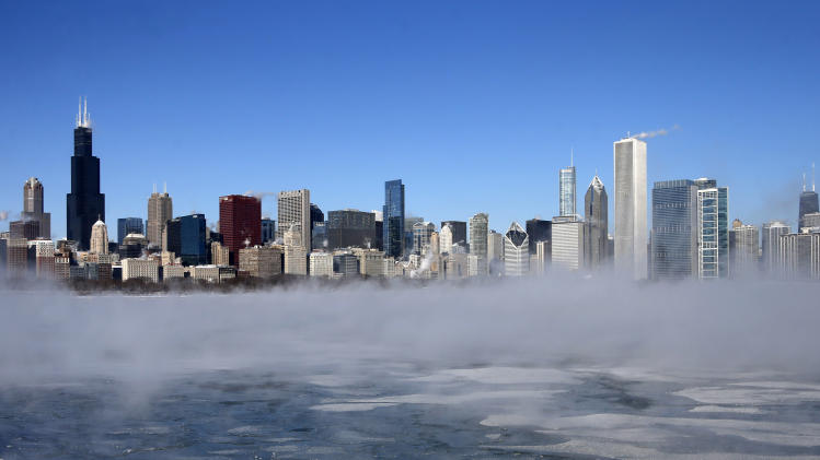 The Chicago Skyline sits as a backdrop as fog drifts across Monroe Harbor with temperatures well below zero and wind chills expected to reach 40 to 50 below, Monday, Jan. 6, 2014, in Chicago. A whirlpool of frigid, dense air known as a "polar vortex" descended Monday into much of the U.S. (AP Photo/Charles Rex Arbogast)