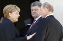 German Chancellor Angela Merkel, left, Russian President Vladimir Putin, right, and Ukrainian president-elect Petro Poroshenko, center, talk after a group photo before a luncheon as they take part in the 70th anniversary of D-Day in Benouville in Normandy, France, Friday, June 6, 2014. World leaders and veterans gathered by the beaches of Normandy on Friday to mark the 70th anniversary of World War Two's D-Day landings. (AP Photo/Regis Duvignau, Pool)