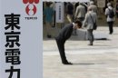 TEPCO staff bows deeply as shareholders enter the venue of the company's annual general shareholders' meeting in Tokyo