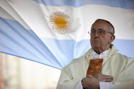 FILE - In this Aug. 7, 2009 file photo, Argentina's Cardinal Jorge Bergoglio gives a Mass outside the San Cayetano church where an Argentine flag hangs behind in Buenos Aires, Argentina. On Wednesday, March 13, 2013, Bergoglio was elected pope, the first ever from the Americas and the first from outside Europe in more than a millennium. He chose the name Pope Francis. (AP Photo/Natacha Pisarenko)