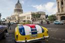 An old car with the Cuban flag painted on the trunk is seen near the Capitol of Havana, on January 7, 2015