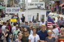 Tourists visit the former Checkpoint Charlie border crossing in Berlin