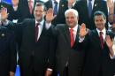 Spanish Primer Minister Mariano Rajoy (L), Panamanian President Ricardo Martinelli (C) and Mexican President Enrique Pena Nieto wave during the family photo of the XXIII Ibero-American Summit, in Playa Bonita Hotel, on October 19, 2013
