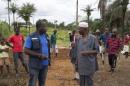 Kamara from WHO speaks with community leaders at the construction site of a Ebola Care Unit in Kamasondo Village