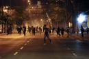Anti-government demonstrators run from tear gas during clashes with riot police at Altamira Square in Caracas