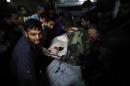 Palestinians react as they gather around the body of a Hamas militant at a hospital in Khan Younis in the southern Gaza Strip