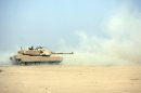 Iraqi troops fire live rounds during a training session with US forces on using American Abrams-M1A1 tanks