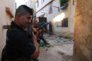 Sunni Muslim gunmen fire their weapons at the Sunni Muslim dominant neighbourhood of Bab al-Tebbaneh in Tripoli, northern Lebanon