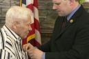 World War II veteran Faulkner is presented the Purple Heart by U.S. Representative Maffei during a ceremony in Auburn, New York