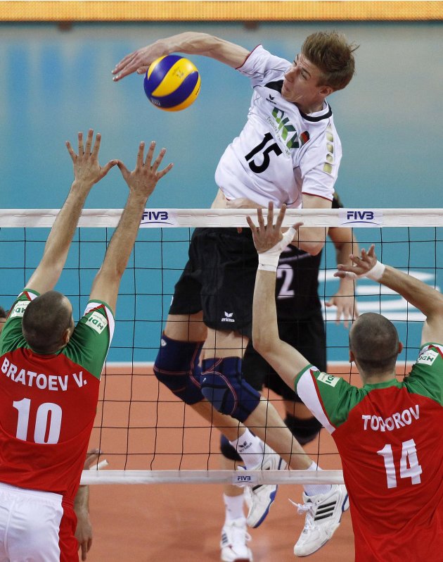 Gunthor of Germany spikes the ball against Bratoev and Todorov of Bulgaria during their FIVB World League Finals in Sofia