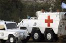 Spanish soldiers of UNIFIL drive an armoured emergency vehicle after picking up the body of a UN peacekeeper from Spain who was killed, in Abbassiyeh on January 28, 2015