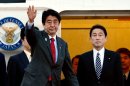 Japanese Prime Minister Shinzo Abe (L) leaves Tokyo International Airport to travel to the US on February 21, 2013