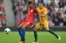 England's striker Marcus Rashford (L) vies for the ball against Australia's Mark Milligan during the friendly football match at the Stadium of Light in Sunderland, England, on May 27, 2016