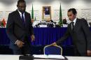 Malian Foreign Minister Abdoulaye Diop (L) prepares to sign a peace agreement as part of mediation talks between the Malian government and some northern armed groups, on March 1, 2015 in Algiers