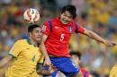 South Korea's Kwak Tae-hwi, right, and Australia's Tim Cahill battle for the ball during the AFC Asian Cup final soccer match between South Korea and Australia in Sydney, Australia, Saturday, Jan. 31, 2015. (AP Photo/Rick Rycroft)