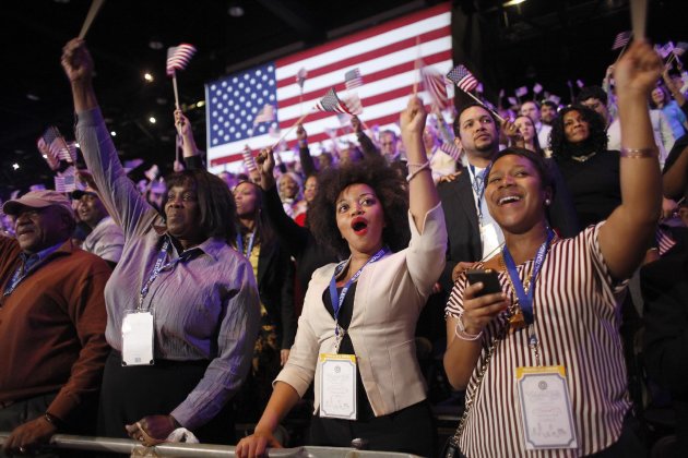 Supporters of President Barack Obama react to favorable media projections at the McCormick Place during an election night watch party in Chicago on Tuesday, Nov. 6, 2012. (AP Photo/Jerome Delay)